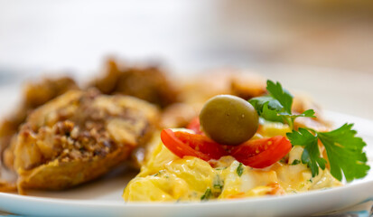 Traditional homemade mayonnaise salad with roasted chicken stuffed with Brazil-style farofa