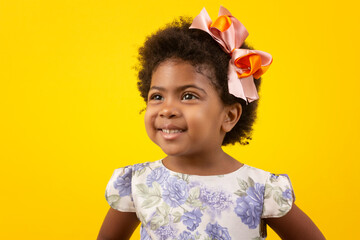 Brazilian black child with curly hair, in studio shot with various facial expressions