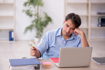 Young male employee working in the office