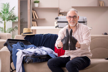 Fototapeta premium Old man preparing for trip at home