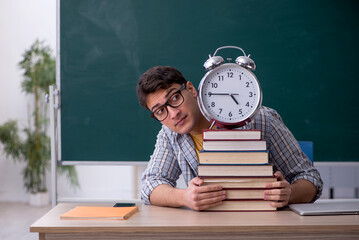 Young male student in time management concept