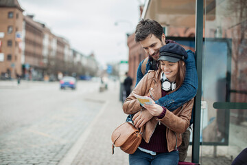 Young couple waiting for their bus at a bus station