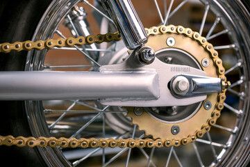Close-up of a motorcycle chain and wheel