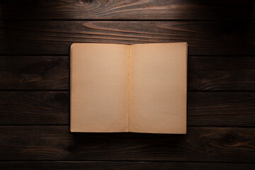 Vintage book, open, on old wooden table, with clipping path. Open Book blank on old wooden background. book with blank pages