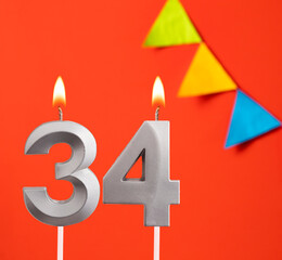 Birthday candle number 34 - Invitation card in orange background