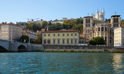 View of Cathedral of Saint-Jean and Notre Dame de Fourviere Basilica on hill on bank of river Saone...