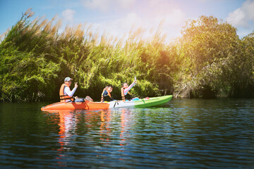 asian family sailing  kayak boat  in fresh water lagoon ,kayaking is one of most popular activity in thailand - 630139222