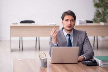 Young male employee working in the office