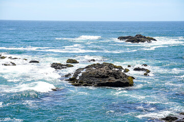 Pacific ocean, California, USA. Rocks, water, and white caps.