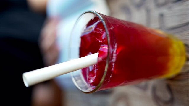 Red bubble tea in a glass with ice