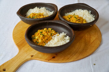 Three delicious chickpeas curry with white rice in beautiful ceramic bowls. Vegetarian food alterantives.