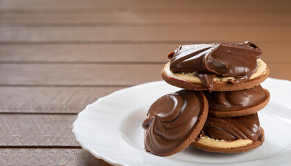 Chocolate sweet melting nougat cream on cookies on a white plate with copy space, horizontal,...