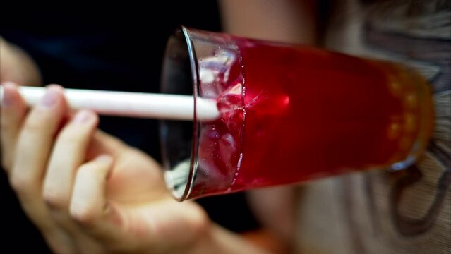 Man drinking red bubble tea