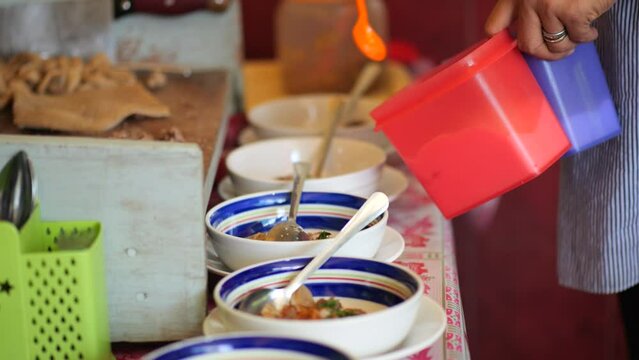 Vendor Preparing Coto Makassar Traditonal Beef Soup. Coto Makassar, traditional food from Makassar, South Sulawesi. made from beef offal mixed with beef, seasoned with specially formulated spices.