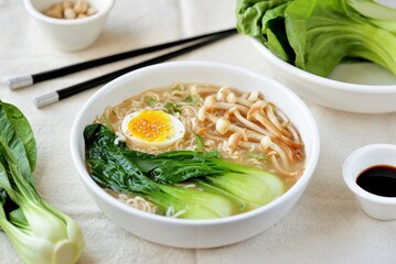 Healthy vegetarian soup with noodles, mushrooms, egg and Chinese cabbage