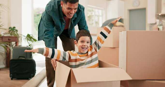 Father, push son and box in new house for games, car or plane with smile, bonding and playful with love. Man, boy child and cardboard for race, speed and excited with care, moving and family home