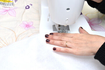 woman using a sewing machine sewing fabrics