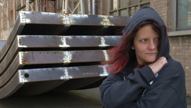Mysterious Girl standing trying to hide her identity. Medium shot slow motion.