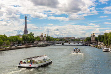 Eiffel tower and river cruise boat on Seine river in Paris, France