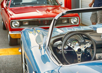 Classic muscle cars on display at vintage automotive show.