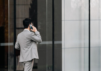 Back view of a businessman talking on the phone. 