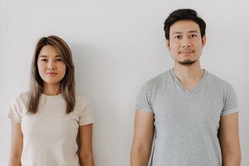 Fototapeta na wymiar Happy smiling asian couple standing isolated on white background.
