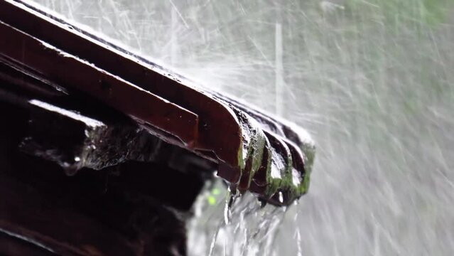 Steady close-up shot of Heavy rain falling on Village House roof - Hd - 30 fps -  Apple ProRes