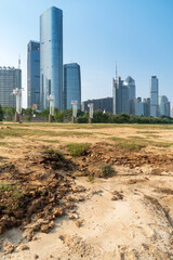 A city looks over a cracked earth landscape