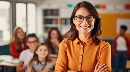 Elementary school teacher in a classroom. Kindergarten class with desks and students. Happy woman smiling.