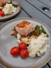Salmon steak dish is being prepared as a family dinner dish.