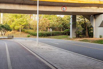 Concrete structure and asphalt road space under the overpass in the city
