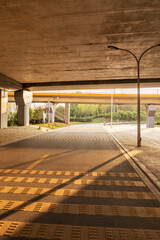 Concrete structure and asphalt road space under the overpass in the city