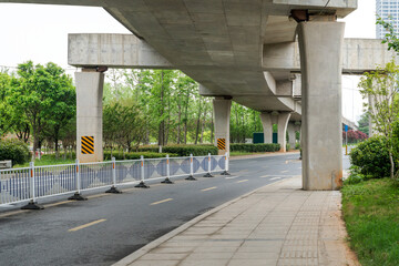 Concrete structure and asphalt road space under the overpass in the city - 630187880