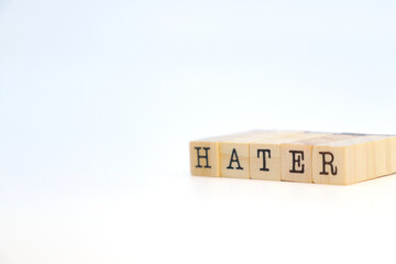 Word hater on wooden cubes. Envy concept