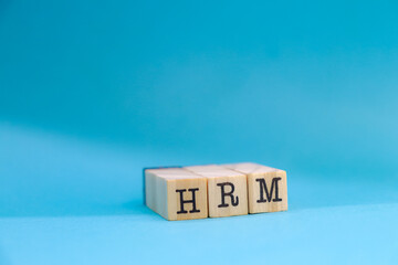 HRM acronym on wooden cubes.
Leadership concept.