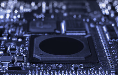 Intricate circuit board with computer hardware, showcasing complexity of electronics industry.