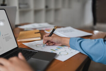 Young business woman looking at computer monitor, analyzing project statistics, marketing research results or statistics data, developing marketing strategy, working at office