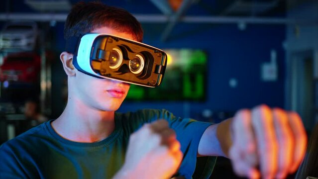 Young engineer with VR virtual reality headset having fun and dancing in research laboratory