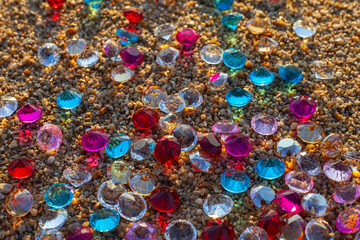 Colorful diamonds on the beach..Each diamond caught the glimmer of the sun, glistening in the sand..The sparkles of the diamonds lit up the shoreline, creating a mesmerizing landscape..