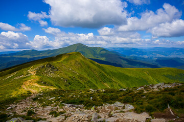 beautiful wide green mountain valley unde dense cloudy sky, summer travel scene