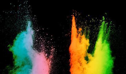 Colorful powder explosion. Colored cloud. Colorful dust explode. Paint Holi on black background