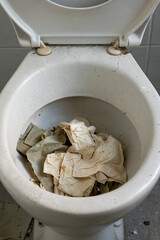 a clogged toilet with paper