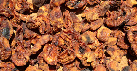 Dark dried apricots background. Healthy food