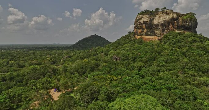 Sigiriya Sri Lanka Aerial v5 flyover and around Sigiriya Rock capturing historical landmark of the ancient ruins surrounded by mountain and lush forest landscape - Shot with Mavic 3 Cine - April 2023