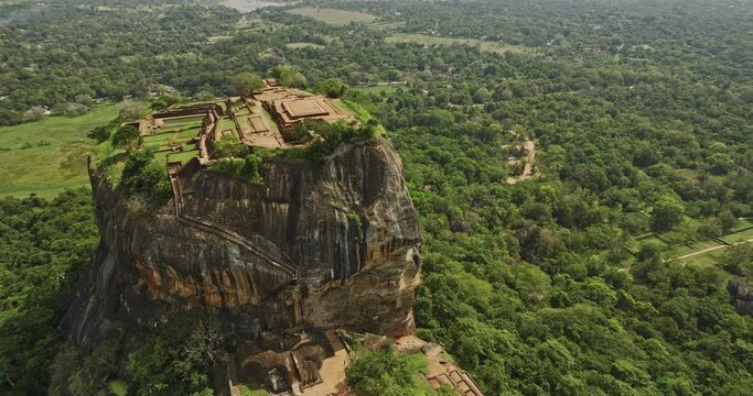 Sigiriya Sri Lanka Aerial v10 drone fly around Sigiriya rock capturing intricate details of ruins, rock fortress, royal residence and surrounding forest landscape - Shot with Mavic 3 Cine - April 2023