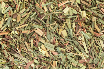 Aromatic dried lemongrass as background, top view.  Cuted dry leaves.