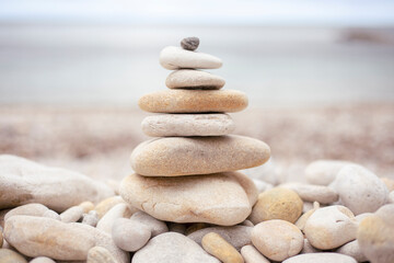 Fototapeta na wymiar Pile of zen-like white stones on the beach that invite calm and reflection