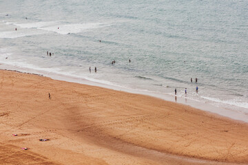 Fototapeta na wymiar Top view of the beach, people resting and the ocean.