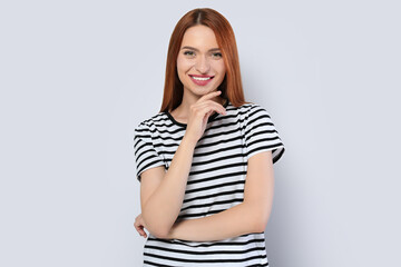 Obraz premium Portrait of beautiful young woman on light gray background