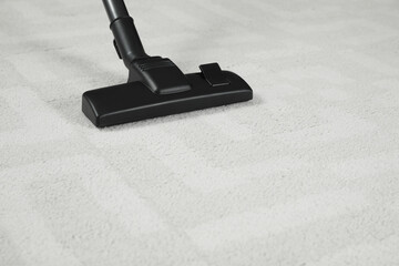 Removing dirt from white carpet with modern vacuum cleaner. Space for text